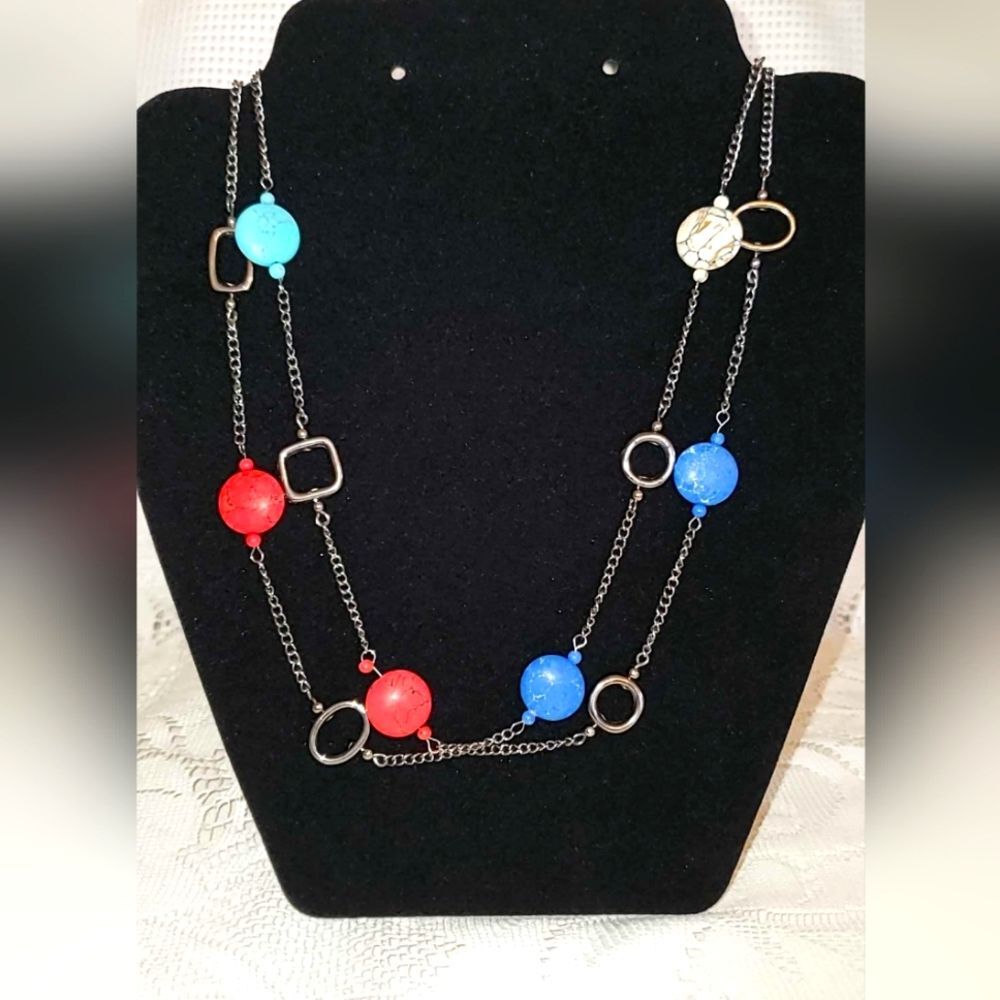 Gunmetal necklace with open shapes adorned with jasper, turquoise, and howlite.